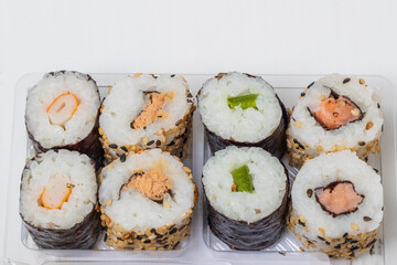 Prepared Japanese sushi in a bowl on a white background.