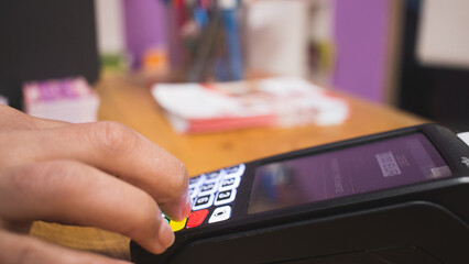 young person preparing payment at his card payment terminal