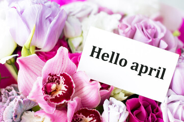 HELLO APRIL inscription on the card on a background of beautiful colors. April is coming, springtime concept