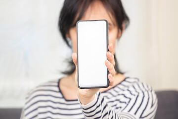 Woman hand holding and showing smartphone screen with blank white background. Mock up
