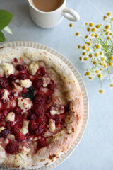 Dessert pizza with raspberries in a plate on the table