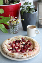 Dessert pizza with raspberries in a plate on the table