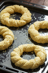 Traditional Turkish sesame simits prepared for baking. Rustic style.