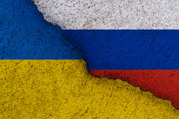 Ukraine and Russia national flags on a grunge texture symbolising war and conflict.