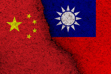 China and Taiwan national flags on a grunge texture symbolising war and conflict.