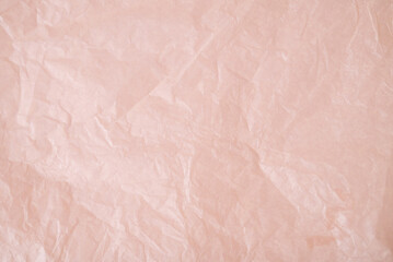 Decorative gift golden bow with ribbons, on a pink background. Gift wrapping for the holiday.