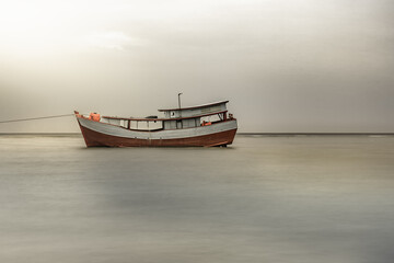 Traditional fishing boat on the beach. horror concept