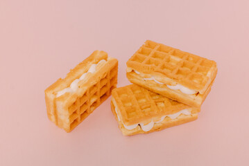 viennese waffles isolated on pink background. Sweet Belgian waffles with toppings on a pink background