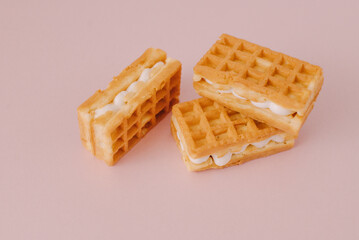 viennese waffles isolated on pink background. Sweet Belgian waffles with toppings on a pink background