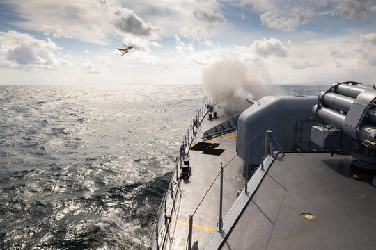 A frigate of Navy makes missile launch during fighting with military aircraft. War ship shoot with gun.