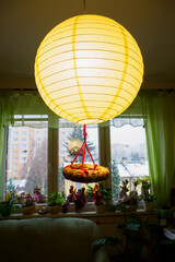 A straw wreath under the living room light.