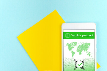 Yellow a piece of paper and smartphone with a valid QR code on blue background.