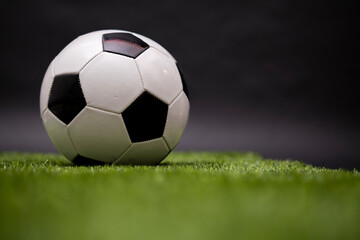 The soccer ball lies on the lawn. Football in the stadium. Football field. Sports competition....