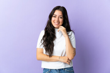 Young caucasian woman isolated on purple background laughing