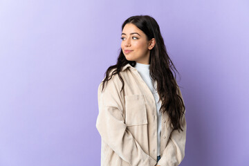 Young caucasian woman isolated on purple background . Portrait