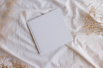 White book mockup with some dry sheets on the bed.