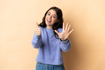 Young caucasian woman over isolated background counting six with fingers