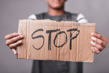Young black man with a cardboard in his hands in protest with the word stop