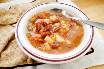 Vegan Garden Vegetable Soup Served in a White Bowl	