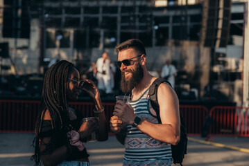 Romantic couple drinking beer and having fun at music festival