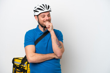 Young brazilian man with thermal backpack isolated on white background looking to the side