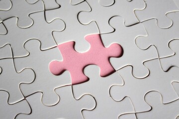 Image of white jigsaw puzzle with missing pieces. Incomplete, solution concept.