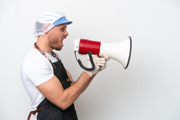 Fishmonger man wearing an apron isolated on white background shouting through a megaphone