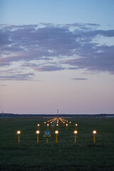 Headlights of runway lights at the airport on the background of the evening sky