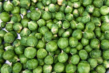 Fresh brussels sprouts in an enameled bowl, view from above. High quality photo