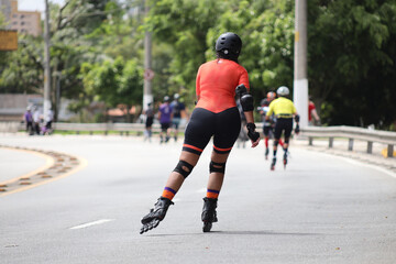 Fototapeta na wymiar woman skates on the road
