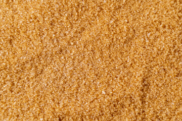 Background of brown raw sugar demerara, top view.