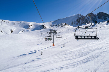 Fototapeta na wymiar People riding ski lift in ski resort