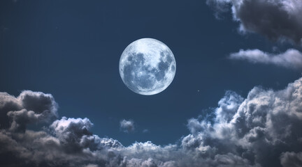 Fototapeta na wymiar The Moon surrounded by clouds. A photo of the moon surrounded by friendly clouds.