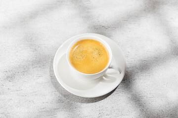 Cup of coffee on white background with hard light