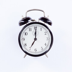 Only time will tell. An alarm clock isolated on white.