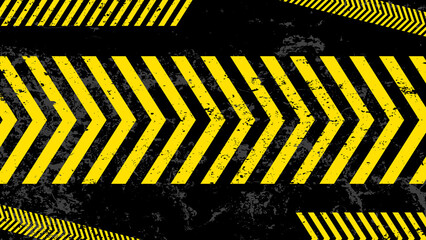 A grungy and worn hazard stripes texture. Abstract warning striped rectangular background, yellow and black stripes on the diagonal, a warning to be careful