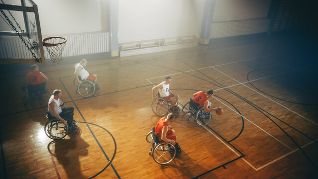 Wheelchair Basketball Game Court: Paraplegic Professional Players Competing, Passing, Shooting Ball. Determination, Inspiration, and Skill of a People with Disability.