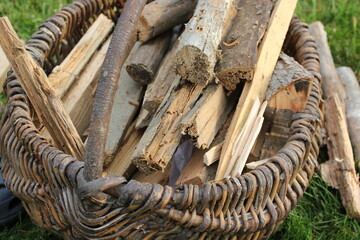 Firewood stacked in braided basket. hd