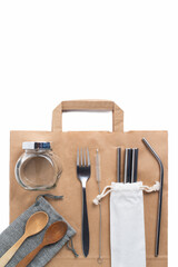 reusable items - glass, iron objects, wooden spoons, paper bag