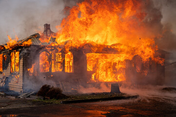 Fototapeta na wymiar A two-story house fully engulfed structure fire