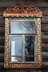 Architectural details - beautiful window framing near old wooden houses. Traditional Russian culture