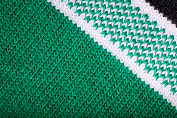Detail of a green fabric sleeve from a polo shirt