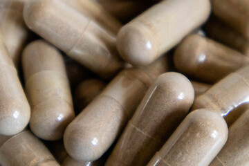 Brown capsules close-up. The scattering of capsules on a light background is close. High quality photo.