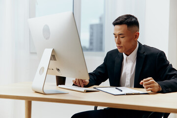 Fototapeta premium Asian man works at the computer emotion office Lifestyle
