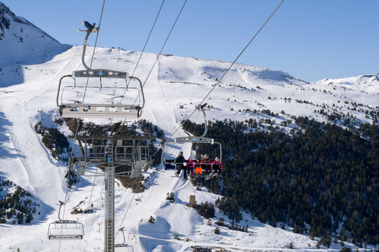 People riding ski lift in ski resort
