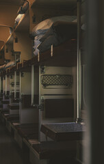 A reserved car of a train without people. Interior of a long-distance train with empty seats in a sleeping car.
