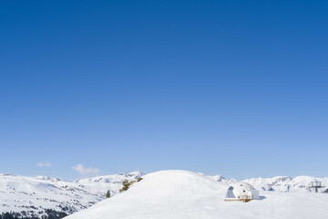Snowy igloo on the mountain slope