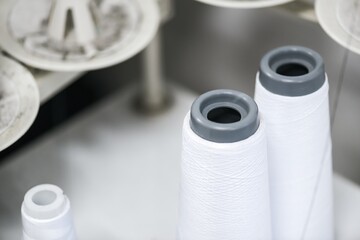 Rollers with nets. It is designed for stitching of semi-fabrics for both household and tailoring workshops. In background with white table and other background.