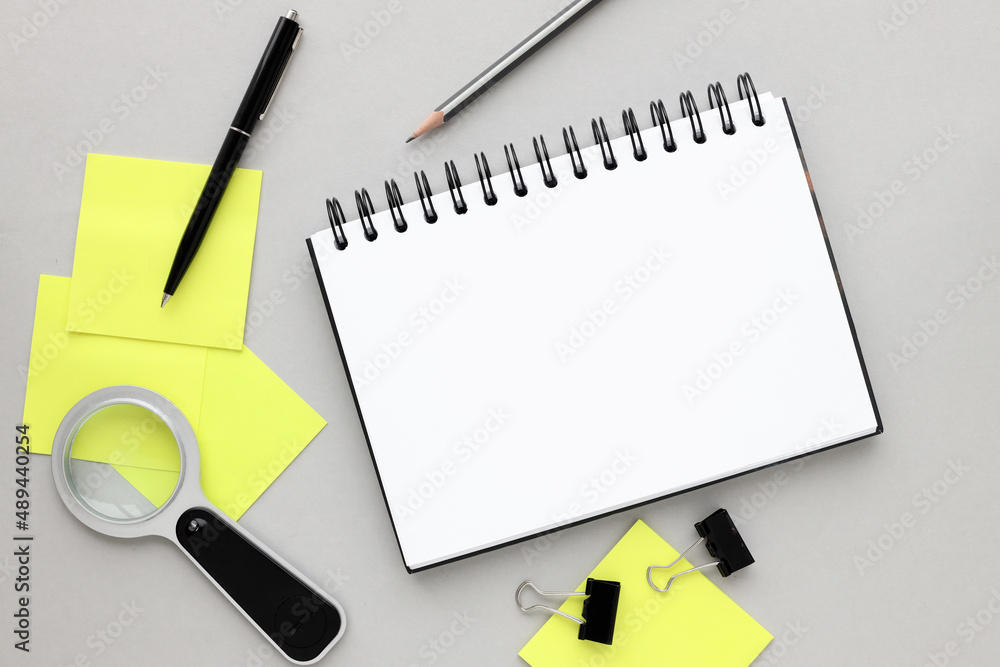 Aufkleber top view of open notepad and yellow sticker with copy space. memo and planning concept. magnifier. p