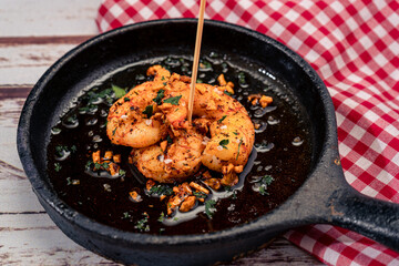 Traditional Spanish dish, typical Mediterranean tapas. Prawns with garlic or shrimp with garlic in olive oil. Traditional food concept.